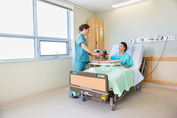 Image showing Nurse Bringing Breakfast For Male Patient In Hospital