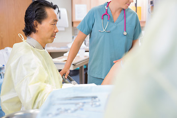 Image showing Male Doctor Delivering Baby in Hospital