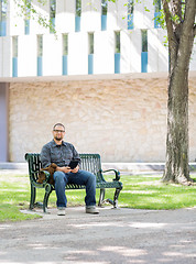 Image showing Student Sitting On Bench At University Campus