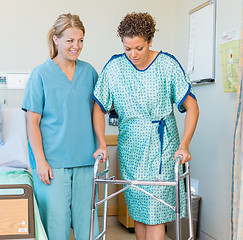 Image showing Patient Using Walker While Nurse Looking At Her