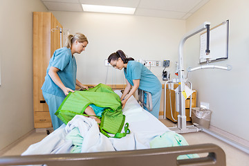 Image showing Nurses Preparing Patient Before Transferring Him On Hydraulic Li