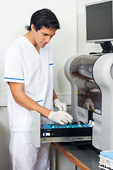 Image showing Researcher Loading Solutions Into Analyzer