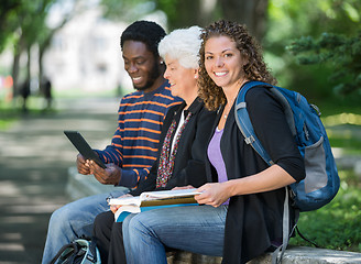 Image showing University Students Sitting On Parapet At Campus