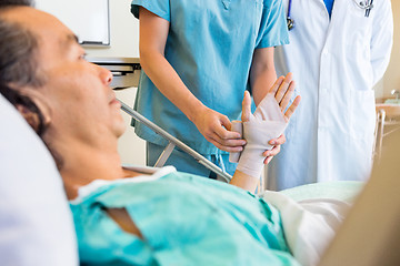 Image showing Nurse Putting Bandage On Patient's Hand In Hospital