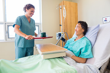 Image showing Friendly Nurse Bringing Breakfast For Patient In Hospital