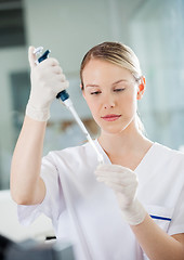 Image showing Healthcare Worker Filling Solution Into Test Tube