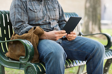 Image showing Midsection Of College Student Using Digital Tablet