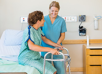 Image showing Nurse Assisting Patient Using Walking Frame In Hospital