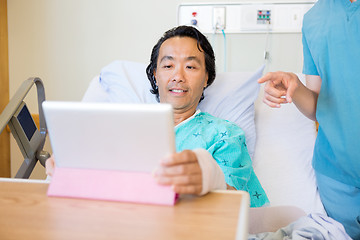 Image showing Nurse Pointing At Digital Tablet While Patient Using It