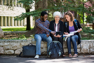 Image showing Happy University Students Using Digital Tablet On Campus