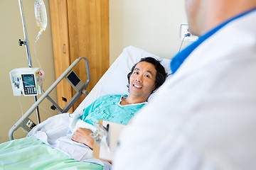 Image showing Happy Patient Looking At Doctor While Lying On Hospital Bed