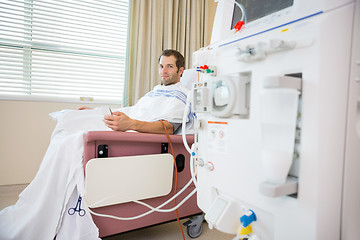 Image showing Patient Holding Cellphone During Renal Dialysis Treatment