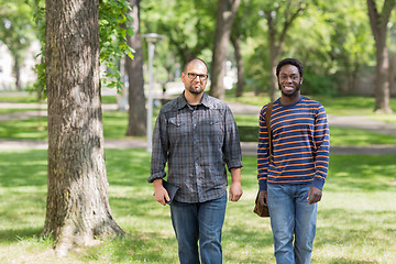 Image showing Confident Grad Students Walking On University Campus