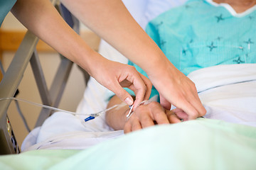 Image showing Nurse Attaching IV Drip On Male Patient's Hand