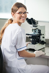 Image showing Confident Female Scientist Using Microscope In Lab