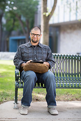 Image showing Smiling Male University Student Sitting On Bench