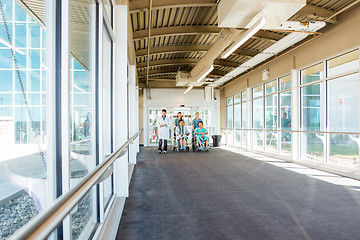 Image showing Medical Team With Patients On Wheelchairs At Corridor In Hospita