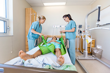 Image showing Nurses Preparing Patient Before Transferring Him On Sling Lift
