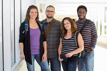 Image showing Confident University Students Standing At Corridor