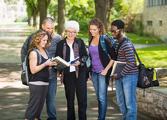 Image showing Students Discussing Notes On Campus