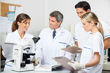 Image showing Researcher With Students Taking Notes In Lab