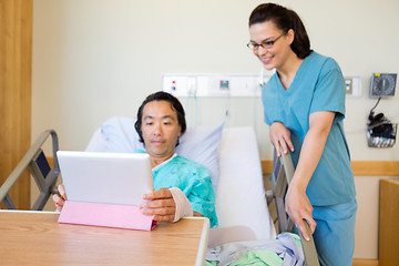 Image showing Nurse And Male Patient Looking At Digital Tablet