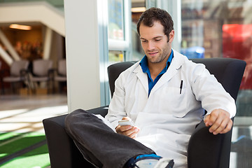 Image showing Doctor Using Mobile Phone On Chair