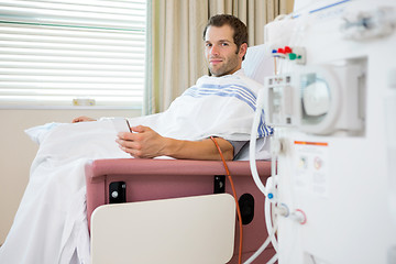 Image showing Patient Holding Mobilephone at Renal Dialysis Center