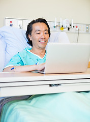 Image showing Happy Patient Using Laptop On Hospital Bed