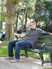 Image showing College Student Using Digital Tablet On Bench