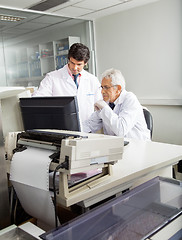 Image showing Researcher Discussing Over Computer