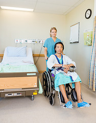 Image showing Male Patient Sitting On Wheelchair While Nurse Assisting Him