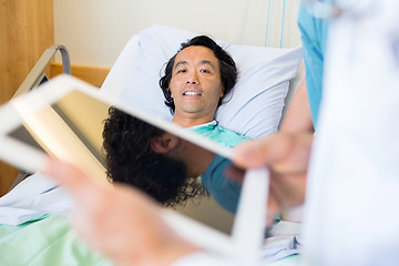 Image showing Patient With Doctor Using Digital Tablet In Foreground