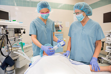 Image showing Nurses Putting Oxygen Mask On Patient