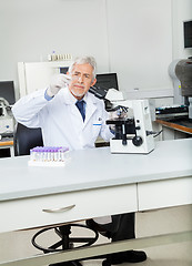Image showing Researcher Analyzing Microscope Slide In Lab