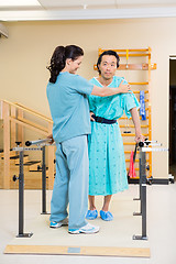 Image showing Physical Therapist Assisting Male Patient In Walking