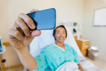 Image showing Male Patient Taking Self Portrait Through Mobile Phone In Hospit