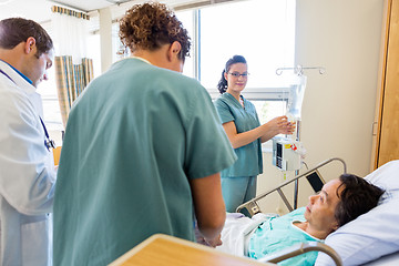 Image showing Medical Team Examining Patient In Hospital