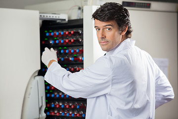 Image showing Researcher Placing Bottles Into Blood Culture Instrument