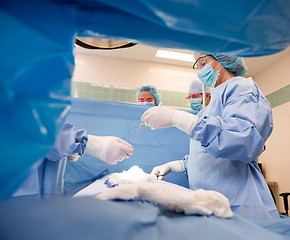 Image showing Team Of Doctors Operating Patient