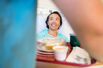 Image showing Happy Patient Looking At Nurse Serving Breakfast