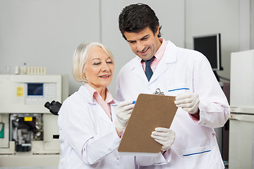 Image showing Technicians Writing On Clipboard In Laboratory
