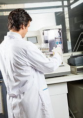Image showing Scientist Analyzing Urine Samples In Laboratory