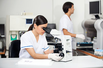 Image showing Female Scientist Using Microscope In Lab