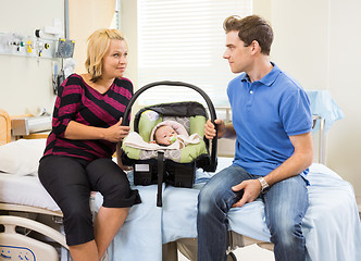 Image showing Couple With Baby Looking At Each Other On Hospital Bed
