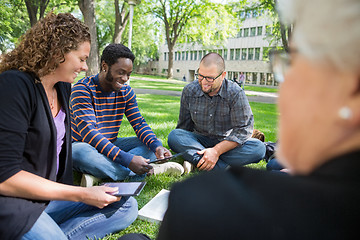 Image showing Group Of Students Using Digital Tablet On Campus