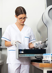 Image showing Researcher Loading Samples Into Analyzer In Lab