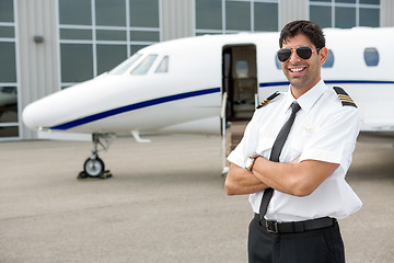 Image showing Smiling Pilot Standing In Front Of Private Jet