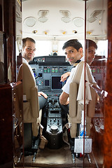 Image showing Pilot And Copilot In Corporate Plane Cockpit