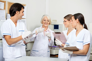 Image showing Scientists Discussing Over Sample In Laboratory